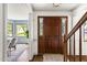 Welcoming foyer with hardwood floors, staircase, and view into the dining room at 16 Cedar Hill Dr, Durham, NC 27713