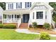 Inviting front entrance with brick steps, a blue door, and manicured landscaping at 16 Cedar Hill Dr, Durham, NC 27713