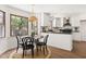 Eat-in kitchen with stainless appliances, stylish lighting, and large window views to outside at 16 Cedar Hill Dr, Durham, NC 27713