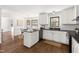 Bright kitchen featuring white cabinets, hardwood floors, and a breakfast bar area at 16 Cedar Hill Dr, Durham, NC 27713