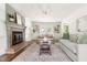 Bright living room with a fireplace, built-in bookshelves, and a neutral color palette at 16 Cedar Hill Dr, Durham, NC 27713