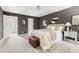 Spacious main bedroom with neutral walls, soft rug, sitting bench, and easy access to ensuite bath at 16 Cedar Hill Dr, Durham, NC 27713