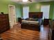 A bedroom features hardwood floors, lots of natural light, and ample space for furniture at 18 Clover Hil Pl, Durham, NC 27712