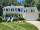 Charming two-story home featuring a welcoming front porch and beautifully landscaped yard at 18 Clover Hil Pl, Durham, NC 27712
