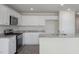 Bright kitchen featuring stainless steel appliances, granite countertops, and white cabinetry at 185 Carriedelle Ln, Wilson's Mills, NC 27577