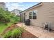 Landscaped backyard with patio, grill, and view of screened porch at 1924 Rustica Dr, Durham, NC 27713