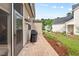 View of outdoor patio with grill and lush landscaping around home at 1924 Rustica Dr, Durham, NC 27713