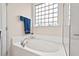 Relaxing bathtub with tiled surround and a privacy window for natural light at 1924 Rustica Dr, Durham, NC 27713