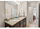 Bathroom features double sinks with granite countertops, tile floors, large mirrors, and updated fixtures at 1924 Rustica Dr, Durham, NC 27713