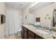 Bathroom featuring double sinks with granite countertops, updated fixtures, and a shower with tub at 1924 Rustica Dr, Durham, NC 27713