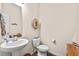 Half bathroom with a pedestal sink and decorative accents adding charm at 1924 Rustica Dr, Durham, NC 27713