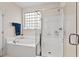 Well-lit bathroom featuring a separate shower and soaking tub at 1924 Rustica Dr, Durham, NC 27713