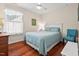 Bedroom bathed in natural light with hardwood floors and simple decor at 1924 Rustica Dr, Durham, NC 27713