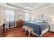 Comfortable primary bedroom with tray ceiling, hardwood floors, and natural light at 1924 Rustica Dr, Durham, NC 27713