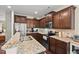 Spacious kitchen with stainless steel appliances, granite countertops, and dark wood cabinetry at 1924 Rustica Dr, Durham, NC 27713