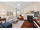 Inviting living room with a fireplace, hardwood flooring, and ample natural light at 1924 Rustica Dr, Durham, NC 27713