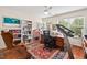 Inviting office with built-in bookshelves, rich wood desk and trim, hardwood floors, and plenty of natural light at 1924 Rustica Dr, Durham, NC 27713