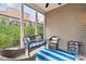 Cozy screened porch featuring cushioned wicker furniture and a ceiling fan at 1924 Rustica Dr, Durham, NC 27713