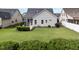 Backyard featuring a lush lawn, a screened porch, and attractive landscaping for private outdoor enjoyment at 20 Sweet Birch Row, Youngsville, NC 27596
