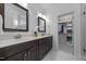 Bathroom with double vanity, granite countertop and mirrors, and a closet at 20 Sweet Birch Row, Youngsville, NC 27596