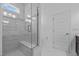 Bathroom with glass-enclosed shower and white tiled walls at 20 Sweet Birch Row, Youngsville, NC 27596
