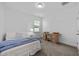 Cozy bedroom with neutral carpet, a built-in desk and a comfortable bed with blue blanket at 20 Sweet Birch Row, Youngsville, NC 27596