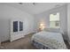 Bright bedroom featuring carpet, a large white wardrobe, and a bed with floral bedding at 20 Sweet Birch Row, Youngsville, NC 27596