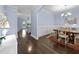 Elegant dining room with hardwood floors, chandelier lighting, and decorative wainscoting, perfect for gatherings at 20 Sweet Birch Row, Youngsville, NC 27596