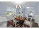 Inviting dining room with classic wainscoting, perfect for entertaining, with views into other living spaces at 20 Sweet Birch Row, Youngsville, NC 27596