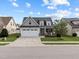 Inviting two-story home featuring a manicured front lawn and a two-car garage, providing ample space at 20 Sweet Birch Row, Youngsville, NC 27596