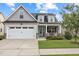 Beautiful two-story home with a two-car garage, complemented by a lush green lawn and a cozy front porch at 20 Sweet Birch Row, Youngsville, NC 27596