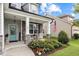 Charming covered front porch with stone accents, rocking chairs, and a beautifully landscaped garden at 20 Sweet Birch Row, Youngsville, NC 27596
