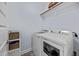 Functional laundry room with modern washer and dryer, plus built in shelving with baskets at 20 Sweet Birch Row, Youngsville, NC 27596