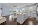 Open concept living area flowing to a kitchen island and ample natural light, perfect for Gathering time at 20 Sweet Birch Row, Youngsville, NC 27596