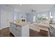 Bright living room with fireplace, island and a view to the neighborhood at 20 Sweet Birch Row, Youngsville, NC 27596