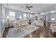 Open living space with a view of the kitchen, a neutral color palette, and lots of light at 20 Sweet Birch Row, Youngsville, NC 27596