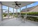 Screened patio area with ceiling fan and furniture, overlooking a well-maintained backyard at 20 Sweet Birch Row, Youngsville, NC 27596