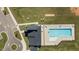 Aerial view of a community pool and clubhouse, alongside parking and recreation area at 20 Sweet Birch Row, Youngsville, NC 27596