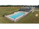 An aerial view of a community pool surrounded by lounge chairs and umbrellas at 20 Sweet Birch Row, Youngsville, NC 27596