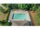 Aerial view of community pool surrounded by trees, lounge chairs, and tables at 20 Sweet Birch Row, Youngsville, NC 27596