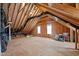 Unfinished attic space showing the wooden frame, venting and two windows for natural light at 20 Sweet Birch Row, Youngsville, NC 27596