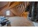 Unfinished attic space showing the wooden frame, venting and a single window for natural light at 20 Sweet Birch Row, Youngsville, NC 27596