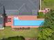 A stunning aerial view showcases a home's pool, patio, landscaping, and roof, giving a comprehensive property perspective at 213 Chimeneas Pl, Chapel Hill, NC 27517