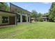 Beautiful backyard featuring a modern home, large lawn, and floor-to-ceiling windows at 213 Chimeneas Pl, Chapel Hill, NC 27517