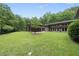 Beautiful backyard featuring mature trees and grass for outdoor entertaining and relaxation at 213 Chimeneas Pl, Chapel Hill, NC 27517