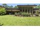 Expansive backyard with lush lawn and landscaped garden beds, offering a serene retreat for outdoor living and relaxation at 213 Chimeneas Pl, Chapel Hill, NC 27517