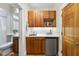 Wet bar with wooden cabinets, mini-fridge, and sink, great for entertaining at 213 Chimeneas Pl, Chapel Hill, NC 27517