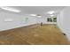 A spacious basement featuring concrete walls, plywood flooring, and natural light, offering a versatile unfinished space at 213 Chimeneas Pl, Chapel Hill, NC 27517