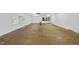 Spacious basement offering a blank canvas, featuring plywood flooring, white-painted walls, and natural light at 213 Chimeneas Pl, Chapel Hill, NC 27517