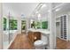 Bright bathroom with double vanity, floor-to-ceiling storage and large windows at 213 Chimeneas Pl, Chapel Hill, NC 27517